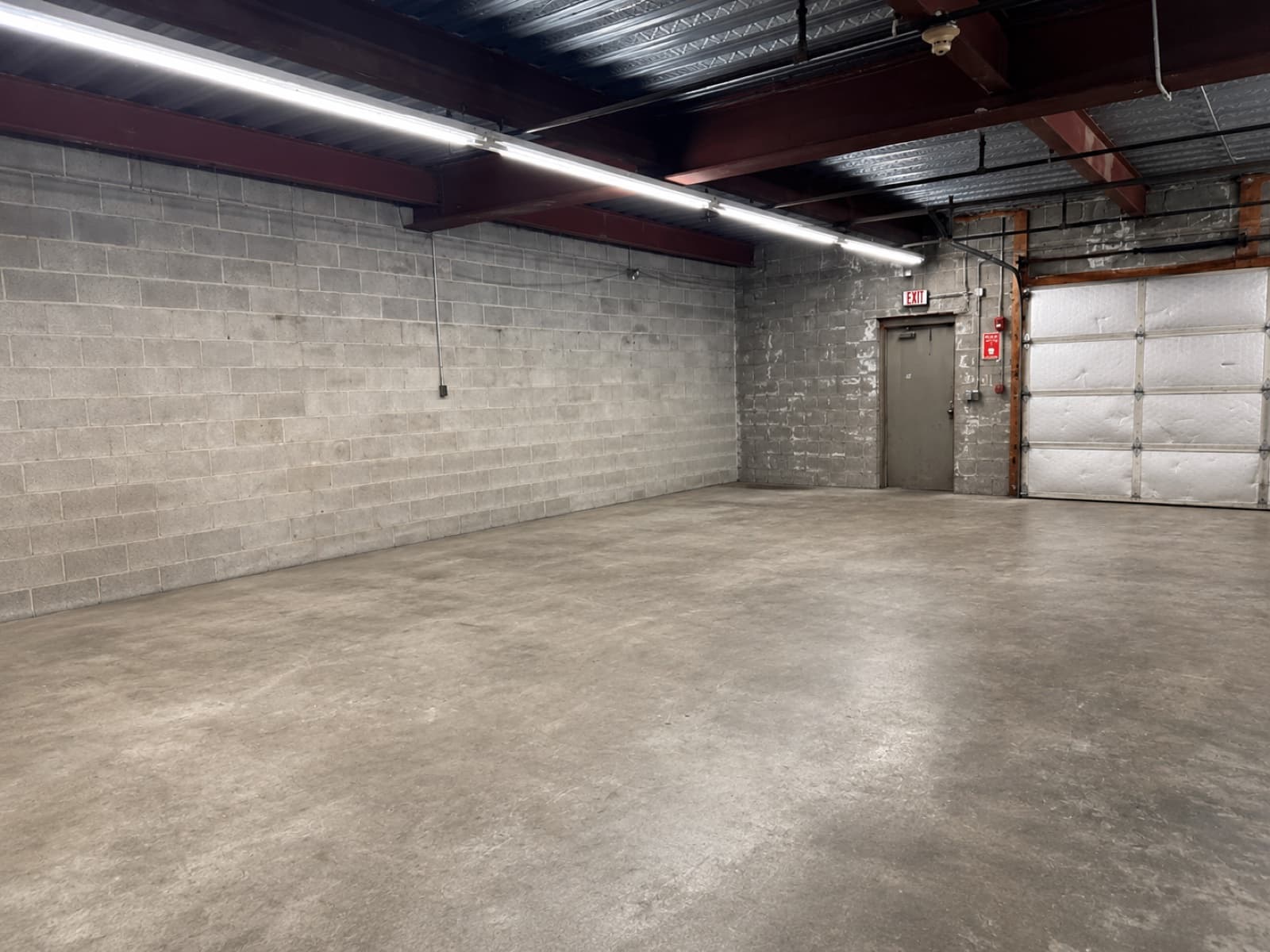 Cleared warehouse floor showing closed overhead loading dock door