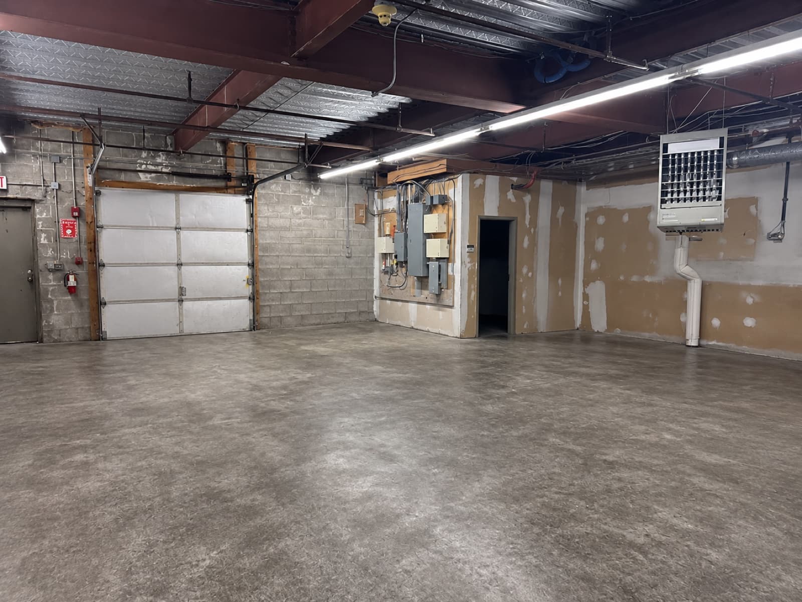 Warehouse interior showing electrical panels and HVAC unit
