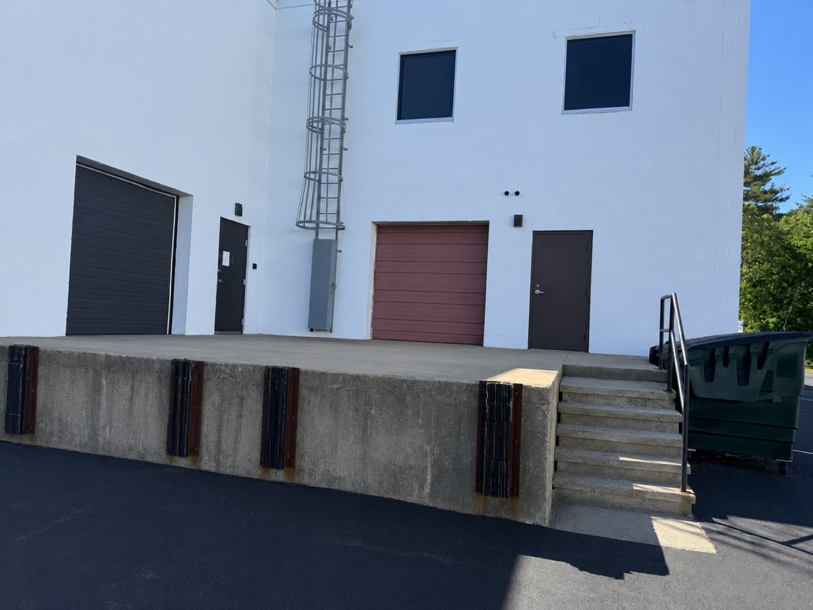 Loading dock exterior with raised concrete platform — Rockland MA warehouse