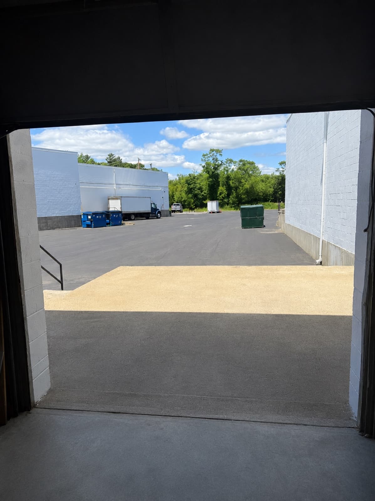 Loading dock interior view looking out at parking lot