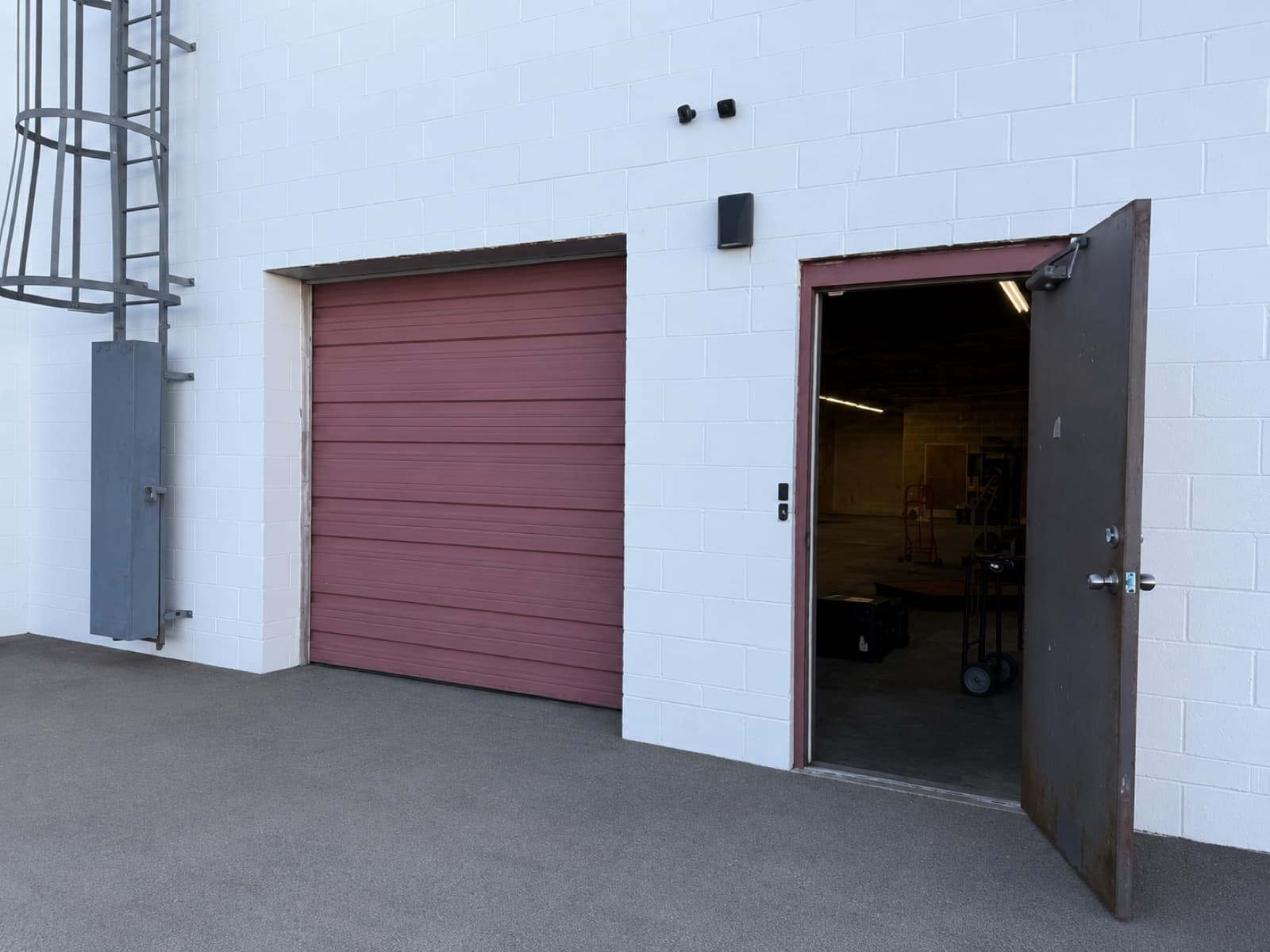 Warehouse side entrance door and adjacent overhead loading door